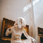 white ceramic figurine on brown wooden table