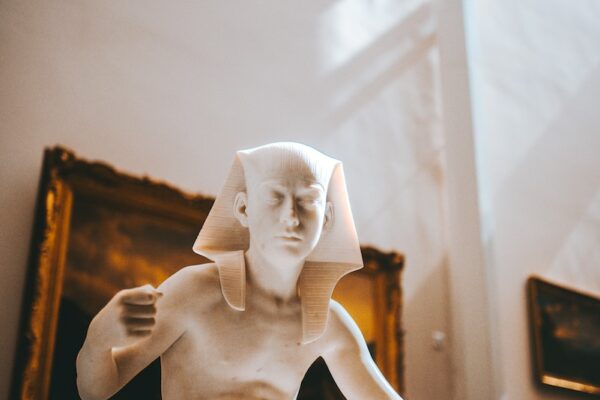 white ceramic figurine on brown wooden table