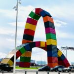 multicolored containers arch during daytime